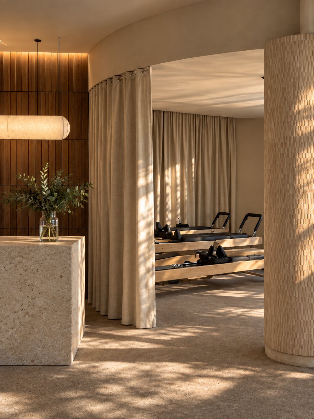 Akasa Studio — Sala de pilates con cortinas translúcidas y columna curva